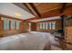Open living space with wood ceilings, fireplace, and an abundance of natural light at 28630 Pine Dr, Evergreen, CO 80439