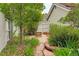 Serene backyard garden with vibrant flowers, stone pathway, and lush greenery at 7409 E Jamison Dr, Centennial, CO 80112