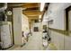 Unfinished basement with exposed ceiling, water heater and various storage options at 7409 E Jamison Dr, Centennial, CO 80112