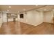 Finished basement with wood flooring, wet bar, and a large screen tv for entertainment at 7409 E Jamison Dr, Centennial, CO 80112