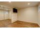 Finished basement with tv and mirrored closet providing ample storage, perfect for Gathering activities at 7409 E Jamison Dr, Centennial, CO 80112
