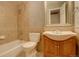 Classic bathroom with tiled walls, tub, and wood vanity, showcasing timeless appeal at 7409 E Jamison Dr, Centennial, CO 80112