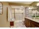 Elegant bathroom featuring granite countertop vanity, tiled shower, and neutral color palette at 7409 E Jamison Dr, Centennial, CO 80112