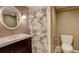 Cozy bathroom featuring a modern sink, vanity, and a shower with a decorative shower curtain at 7409 E Jamison Dr, Centennial, CO 80112