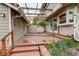 Covered outdoor deck area with wood flooring, outdoor lighting, and a barbecue grill at 7409 E Jamison Dr, Centennial, CO 80112