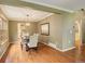 Dining room featuring hardwood floors, a stylish chandelier, and large windows for natural light at 7409 E Jamison Dr, Centennial, CO 80112