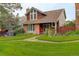 Charming brick and shingle home featuring mature landscaping and a tile roof at 7409 E Jamison Dr, Centennial, CO 80112