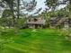 Well-kept two-story home with brick and shingle exterior and a spacious lawn with mature trees at 7409 E Jamison Dr, Centennial, CO 80112