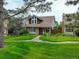 Inviting two-story home with brick and shingle, a well-manicured lawn and beautiful landscaping at 7409 E Jamison Dr, Centennial, CO 80112
