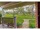 Inviting front porch with views of the lush green lawn, mature trees, and neighborhood at 7409 E Jamison Dr, Centennial, CO 80112