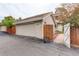 Detached garage with driveway and wood gate leading to the backyard at 7409 E Jamison Dr, Centennial, CO 80112
