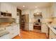 Modern kitchen with stainless steel appliances, granite countertops, and white cabinets at 7409 E Jamison Dr, Centennial, CO 80112