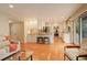 Open kitchen and living area with stainless steel appliances, hardwood floors, and bright lighting at 7409 E Jamison Dr, Centennial, CO 80112