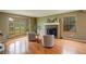 Inviting living room with hardwood floors, fireplace and a large bay window with backyard views at 7409 E Jamison Dr, Centennial, CO 80112