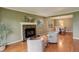 Warm living room with hardwood floors, fireplace, and an open layout to the dining room for entertaining at 7409 E Jamison Dr, Centennial, CO 80112