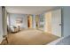 Bright main bedroom with neutral walls, ample closet space, and a cozy sitting area at 7409 E Jamison Dr, Centennial, CO 80112