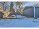 Fenced backyard with a gate and a small, snow-covered area at 4770 S Jason St, Englewood, CO 80110