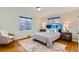 Main bedroom with hardwood floors, a blue headboard, and nightstands at 4770 S Jason St, Englewood, CO 80110