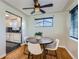 Dining area features hardwood floors, a round wooden table, and white chairs at 4770 S Jason St, Englewood, CO 80110