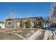 Newly renovated ranch home featuring a gray exterior, landscaped yard, and attached garage at 4770 S Jason St, Englewood, CO 80110