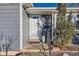 White front door entrance with black metal railing and landscaping at 4770 S Jason St, Englewood, CO 80110