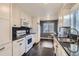 Modern kitchen with white cabinets, granite countertops, and stainless steel appliances at 4770 S Jason St, Englewood, CO 80110