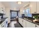 Modern kitchen with white cabinets, granite countertops, and stainless steel appliances at 4770 S Jason St, Englewood, CO 80110