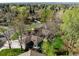 Aerial view of a home surrounded by lush trees and greenery, showing the neighborhood at 4951 Sanford W Cir, Cherry Hills Village, CO 80113