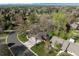 Aerial view of a home in a wooded neighborhood, showcasing its landscaping and cul-de-sac location at 4951 Sanford W Cir, Cherry Hills Village, CO 80113