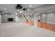 Finished basement with grey brick fireplace, projector and combo flooring at 4951 Sanford W Cir, Cherry Hills Village, CO 80113