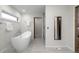 Bright bathroom featuring a modern soaking tub, walk-in shower, and sleek finishes at 4951 Sanford W Cir, Cherry Hills Village, CO 80113