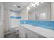 Bathroom featuring a white vanity, modern mirror, shower and toilet with blue tiling at 4951 Sanford W Cir, Cherry Hills Village, CO 80113