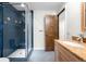 Updated bathroom featuring a walk-in shower, granite vanity, and stylish finishes at 4951 Sanford W Cir, Cherry Hills Village, CO 80113