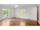 Bright bedroom features hardwood floors, two windows, and a ceiling fan at 4951 Sanford W Cir, Cherry Hills Village, CO 80113