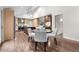 Bright dining area with modern table and chairs, hardwood floors, and seamless flow to the gourmet kitchen at 4951 Sanford W Cir, Cherry Hills Village, CO 80113