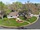 Charming home with a well-manicured lawn, mature trees, and inviting red front door at 4951 Sanford W Cir, Cherry Hills Village, CO 80113