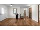 Inviting foyer with hardwood floors, a modern table, and an open view to the staircase at 4951 Sanford W Cir, Cherry Hills Village, CO 80113