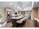 Gourmet kitchen boasts a large island with seating, stainless steel appliances, and custom cabinetry at 4951 Sanford W Cir, Cherry Hills Village, CO 80113