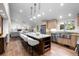 Open-concept kitchen with center island, stainless steel appliances, and a seamless connection to the living area at 4951 Sanford W Cir, Cherry Hills Village, CO 80113