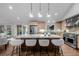 Well-appointed kitchen featuring a large center island, stainless steel appliances, and custom cabinetry at 4951 Sanford W Cir, Cherry Hills Village, CO 80113