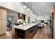 Open-concept kitchen with a large granite island, stainless steel appliances, and hardwood floors at 4951 Sanford W Cir, Cherry Hills Village, CO 80113