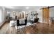 Bright, spacious living room boasting hardwood floors, stylish decor, and a sliding barn door at 4951 Sanford W Cir, Cherry Hills Village, CO 80113