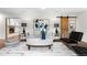 Spacious living room with hardwood floors, modern decor, and an open layout to the backyard at 4951 Sanford W Cir, Cherry Hills Village, CO 80113