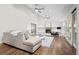 Elegant living room with vaulted ceilings, hardwood floors, a fireplace, and seamless access to outdoor living at 4951 Sanford W Cir, Cherry Hills Village, CO 80113