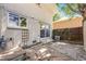 Brick home with sliding glass door to backyard patio at 9026 E Mansfield Ave, Denver, CO 80237