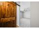 Bedroom with barn door and ceiling fan at 9026 E Mansfield Ave, Denver, CO 80237