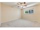 Light and airy bedroom with ceiling fan, carpeted floors, and window at 9026 E Mansfield Ave, Denver, CO 80237