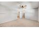 Spacious bedroom with ceiling fan and access to bathroom at 9026 E Mansfield Ave, Denver, CO 80237