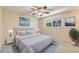 Well-lit bedroom with ceiling fan, carpeted floors, and ample space at 9026 E Mansfield Ave, Denver, CO 80237