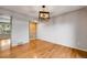 Dining area with hardwood floors and a modern light fixture at 9026 E Mansfield Ave, Denver, CO 80237